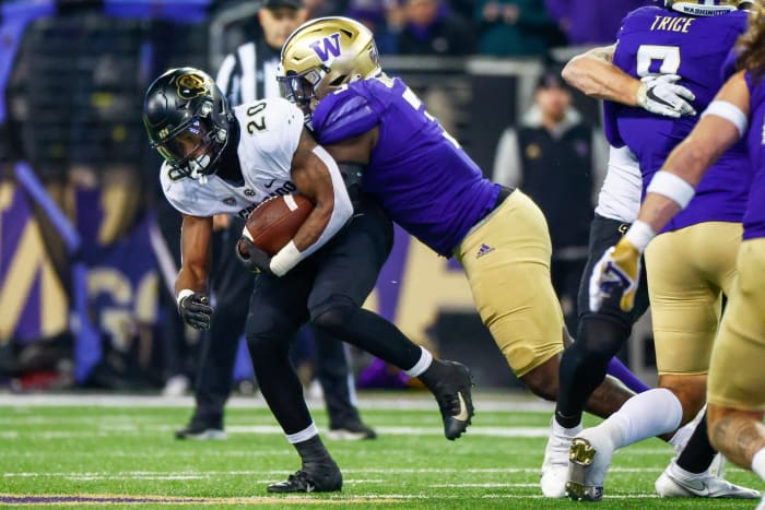 Seattle, Washington, USA; Washington Huskies defensive lineman Jeremiah Martin (3) tackles Colorado Buffaloes running back Deion Smith (20) during the second quarter at Alaska Airlines Field at Husky Stadium.